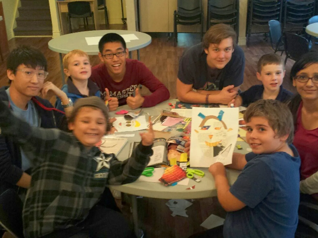 A group of children and mentors smiling and laughing